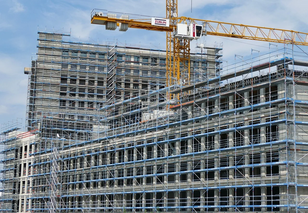 Cranes and scaffolding at a large building construction site