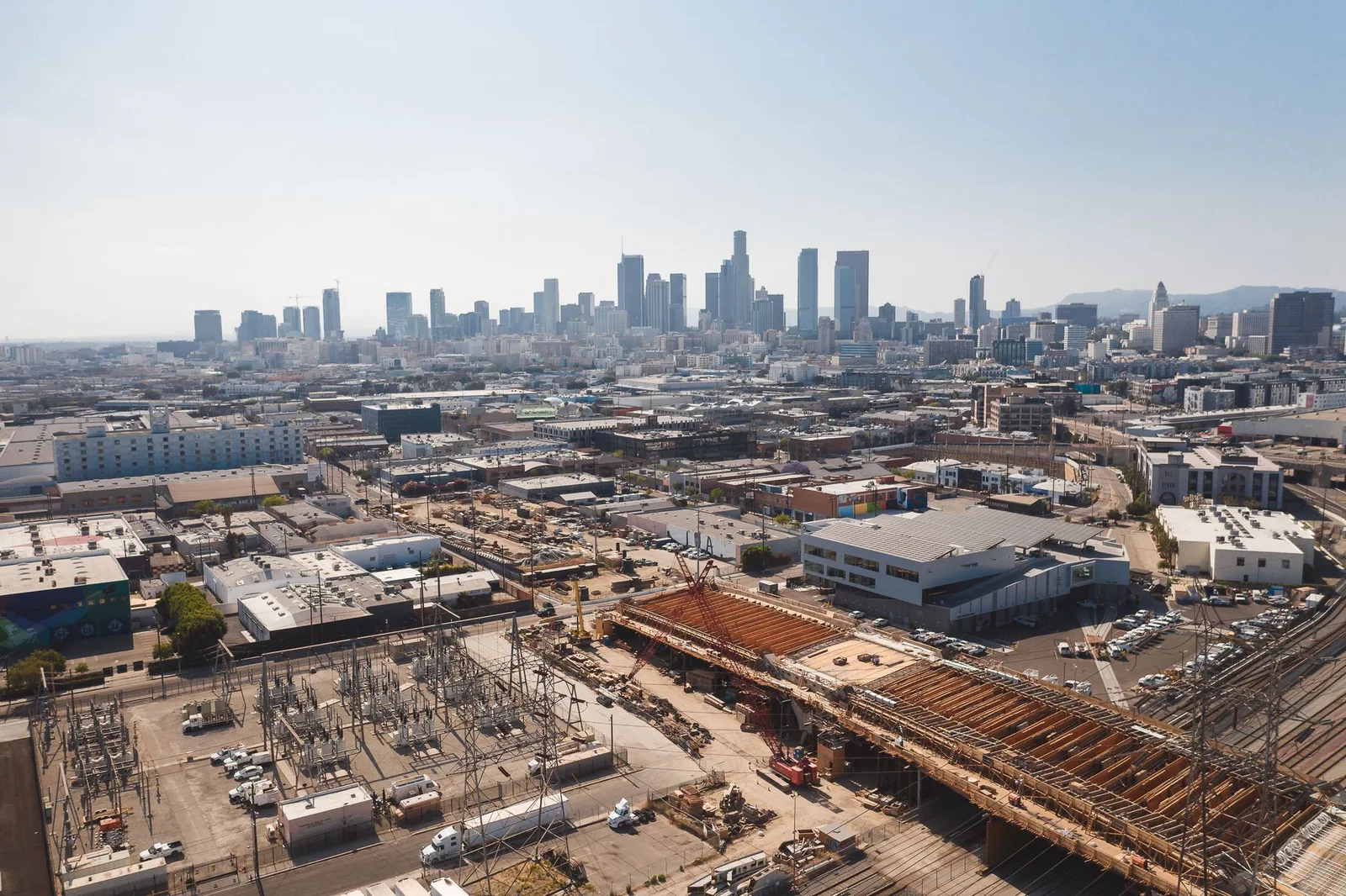 Urban development district with construction sites and a distant skyline