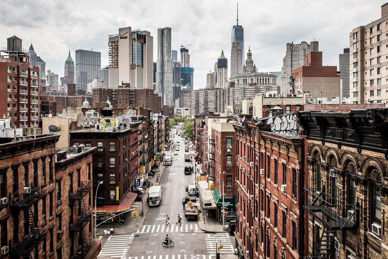 A dense city corridor with mixed-use buildings and commercial towers