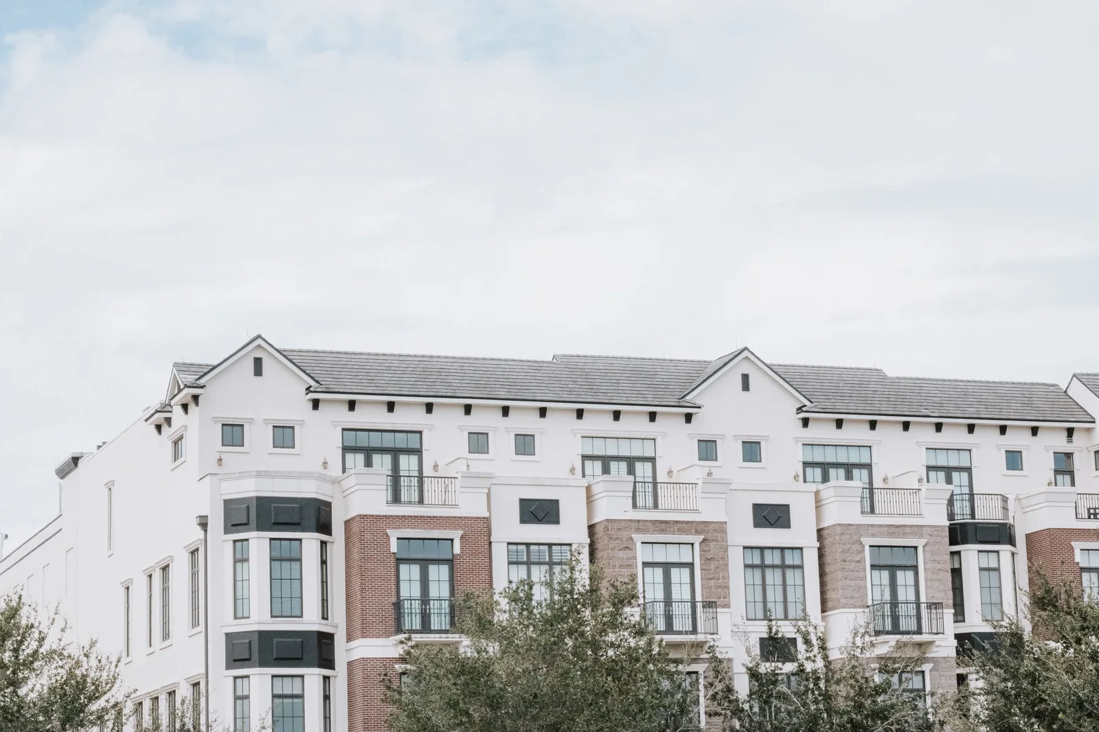 Apartment community with balconies and landscaped grounds
