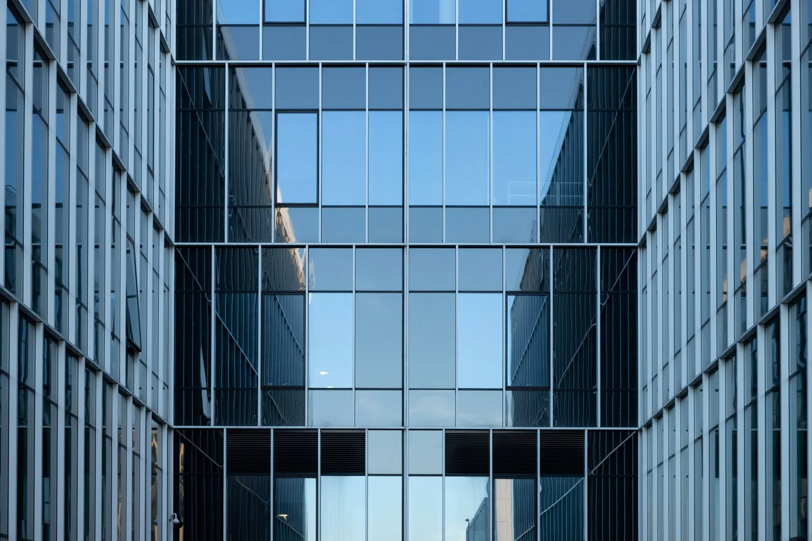 Modern glass office facade with a precise architectural grid