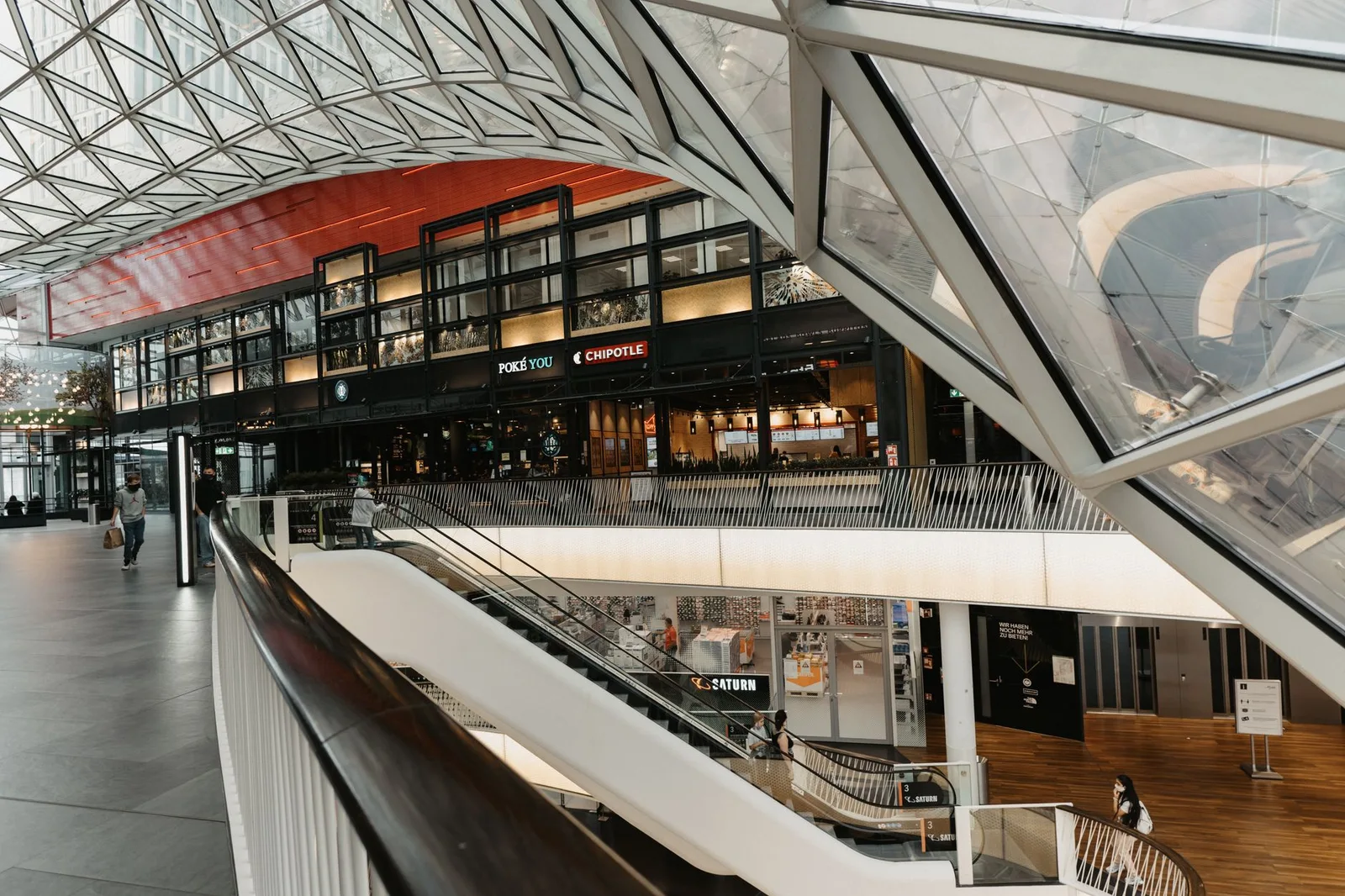 Multi-level shopping center with a glazed architectural roof